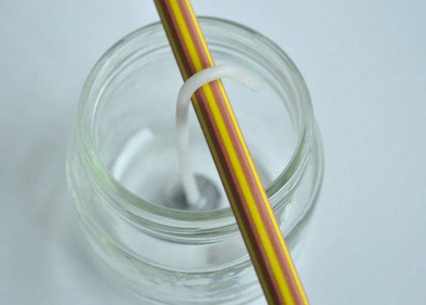 عکس پیچاندن فتیله دور مداد درست کردن شمع در خانه