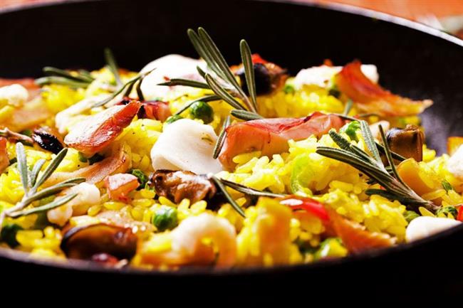 Cooking up a tantalising seafood paella. Photo: avs/Shutterstock