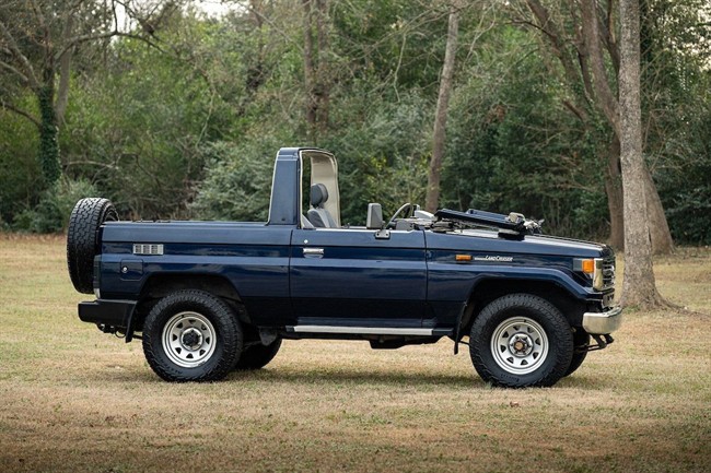 نمای تویوتا لندکروزر سری 70 مدل HZJ73 با بدنه کروک و شیشه جلوی تاشو در فضای باز.